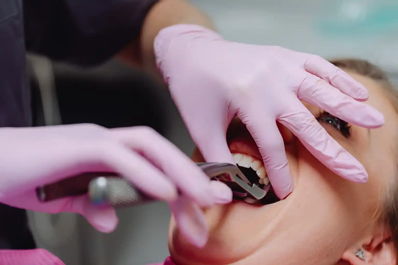 A dentist reviewing dental imaging before planning a tooth extraction
