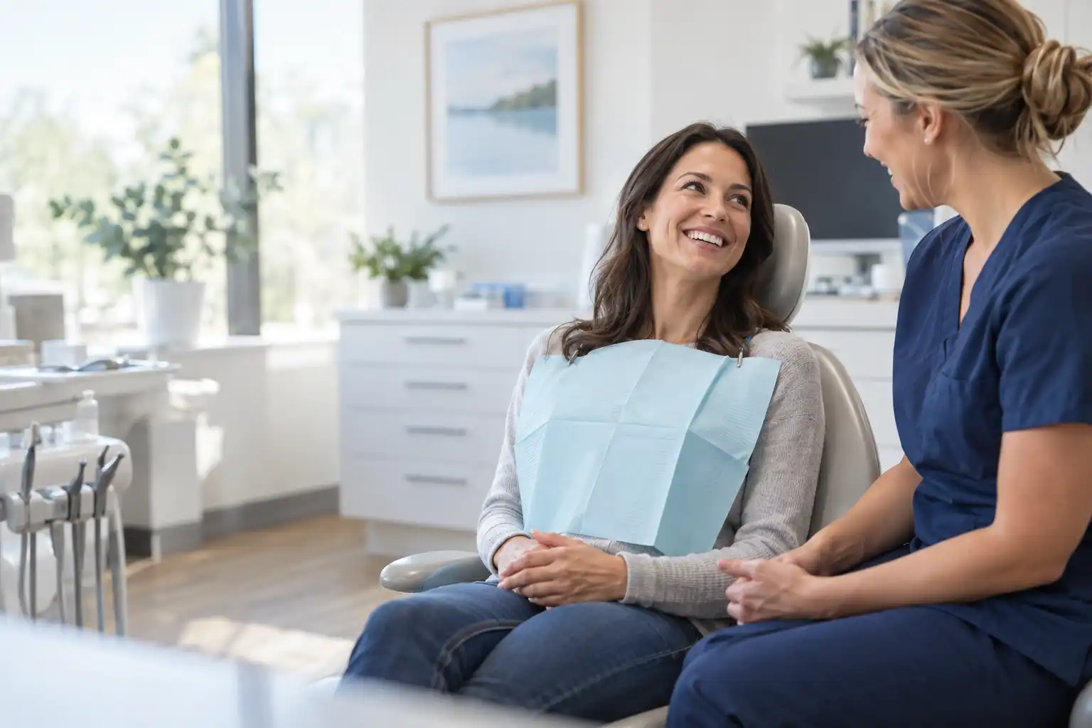 Smiling patient talking with a dental hygienist at Finesse Dental in Rancho Cucamonga