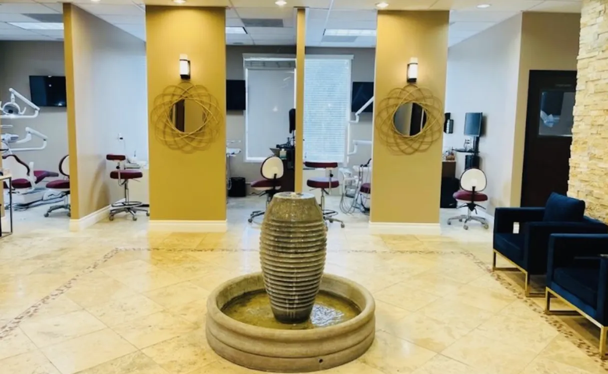 The treatment floor at Finesse Dental in Rancho Cucamonga, with open operatories around a stone water feature