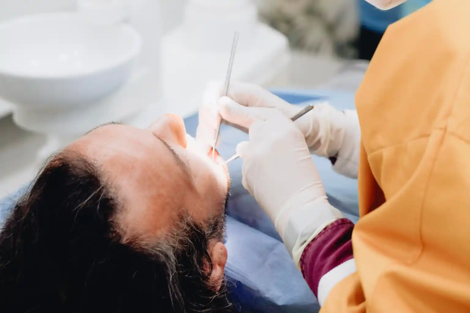 A dentist reviewing 3D dental imaging of a tooth root on a screen